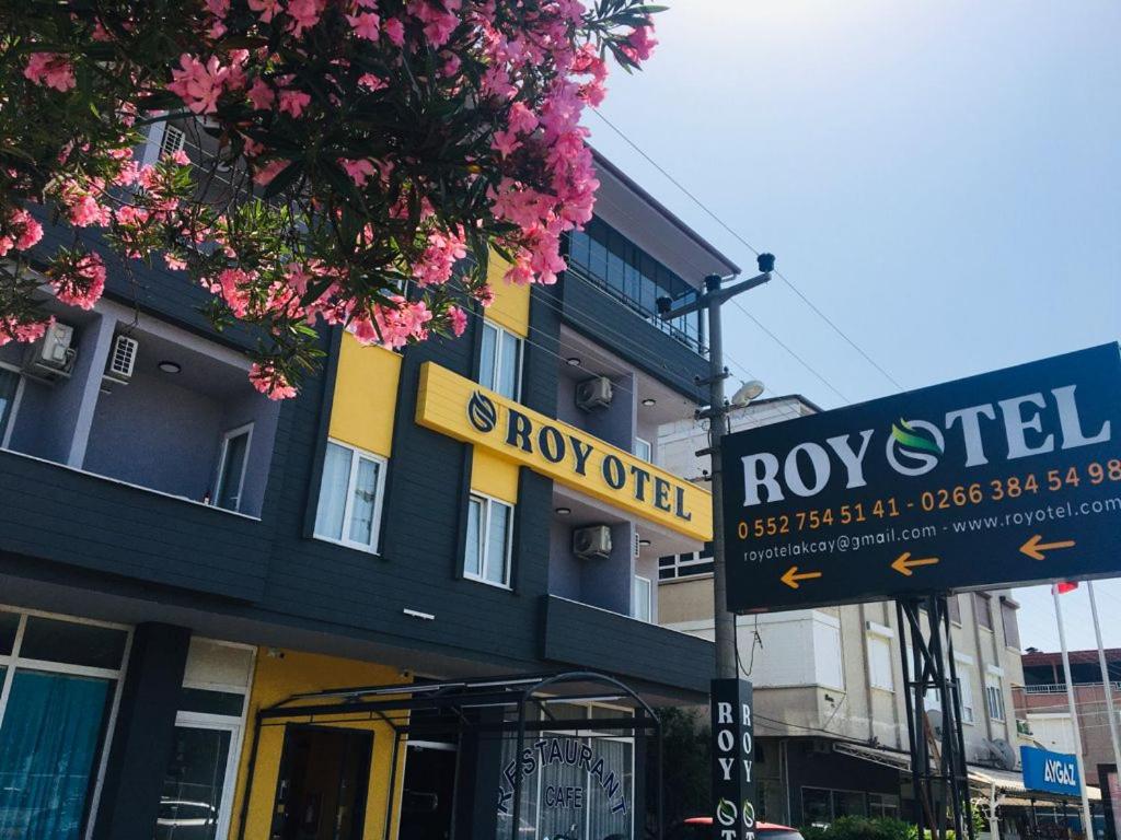 a street sign in front of a building at Roy Otel Akçay in Akcay