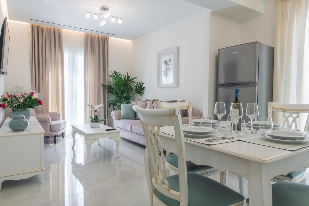a living room with a table and a dining room at Narya Luxury Apartment in Agios Rokkos