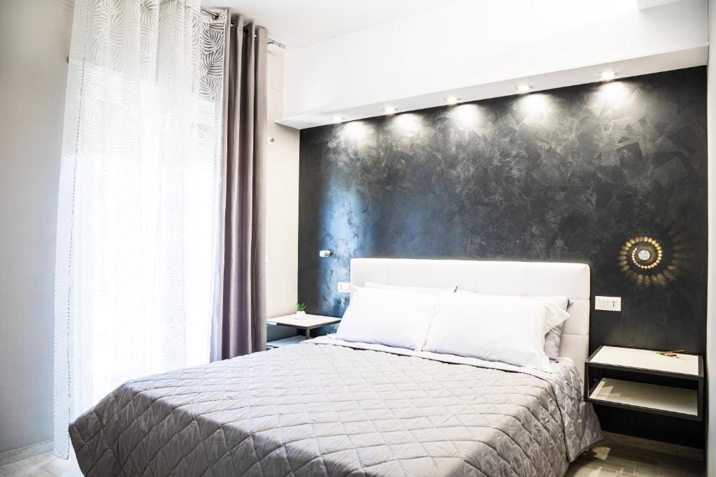 ein Schlafzimmer mit einem Bett und einer schwarzen Wand in der Unterkunft Ninfa Marina in Termoli