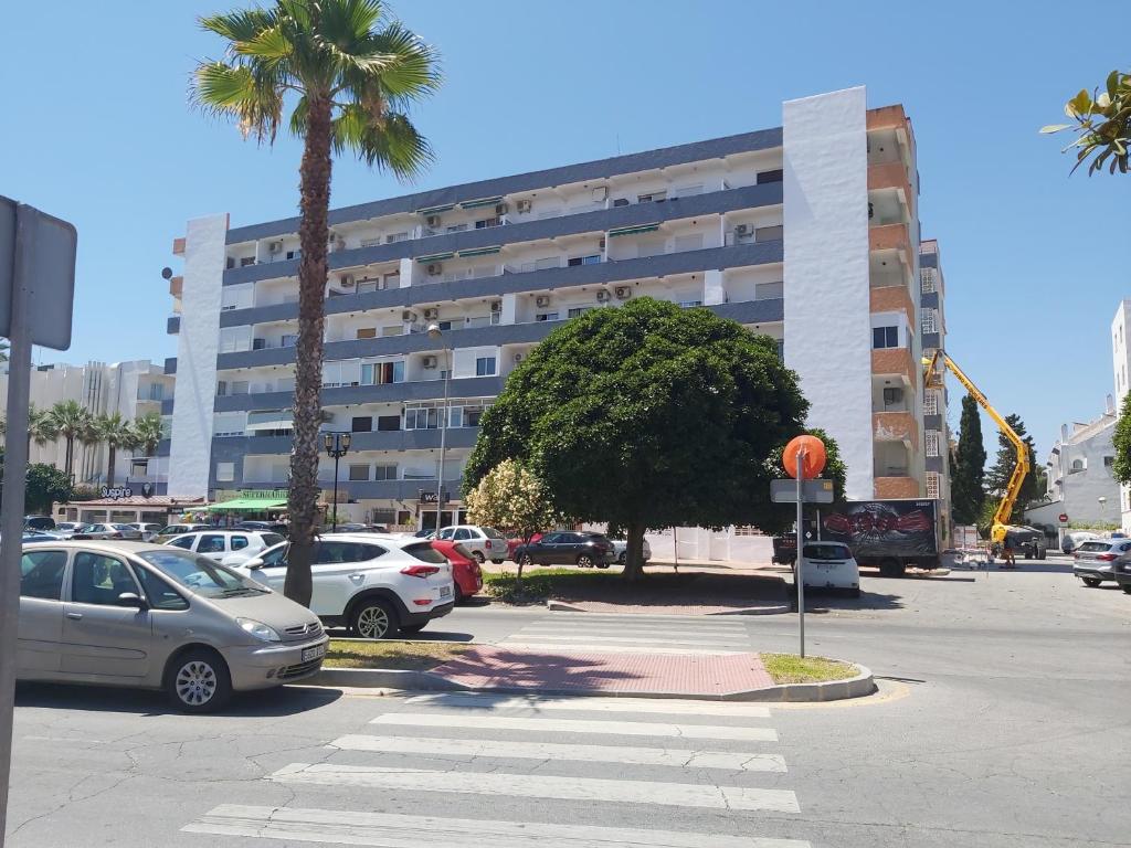 un estacionamiento con autos estacionados frente a un edificio en CABOMOLINOS, APARTAMENTO108, en Torremolinos