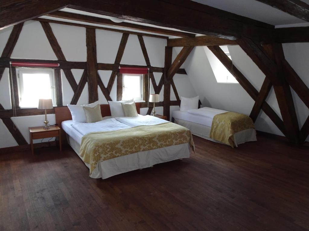 a bedroom with two beds and two windows at Altstadthotel Molitor in Bamberg