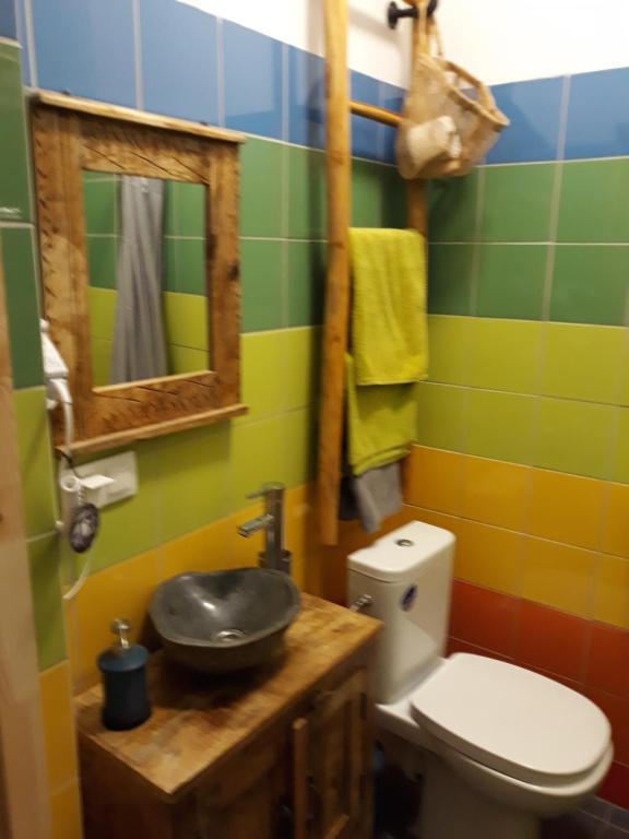 a bathroom with a toilet and a sink and a mirror at Wioska pod Kogutem in Krępa