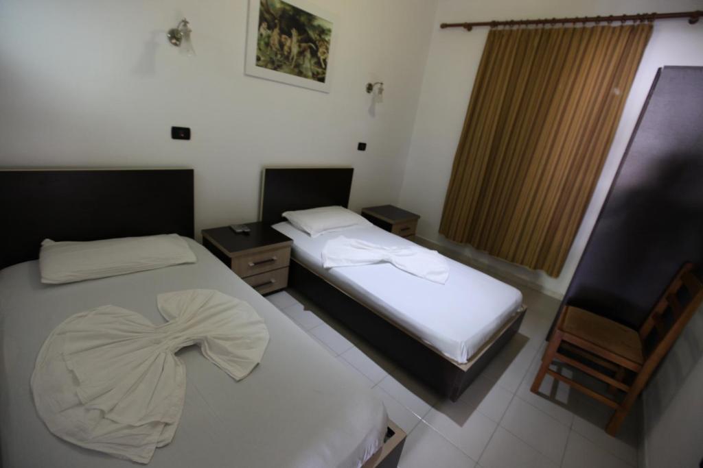 Postel nebo postele na pokoji v ubytování Hotel Colosseo
