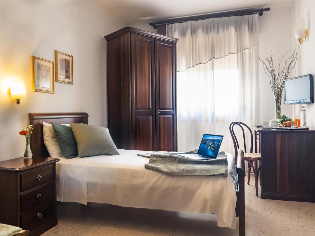 Postel nebo postele na pokoji v ubytování Hotel Da Gigi