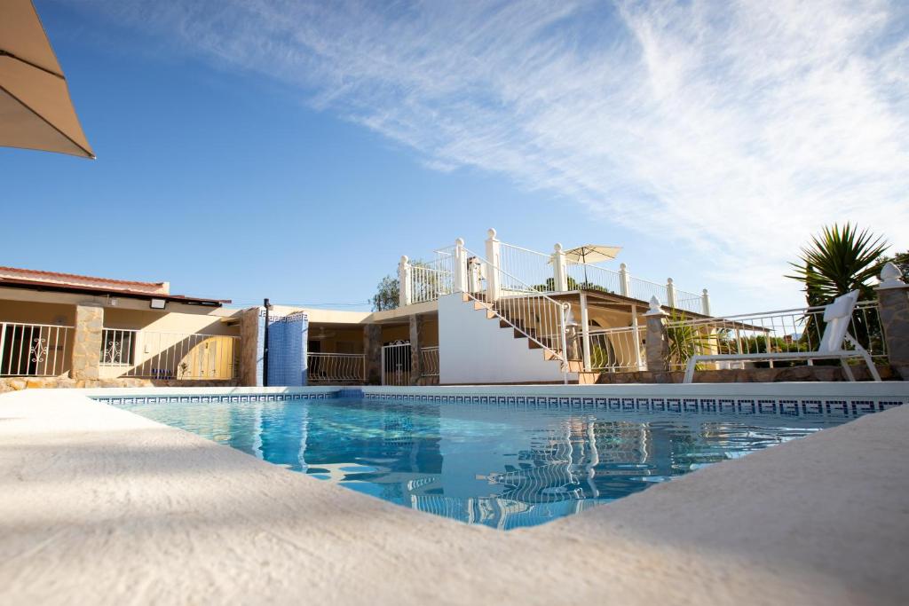 a swimming pool in front of a house at La Casita in Mutxamel