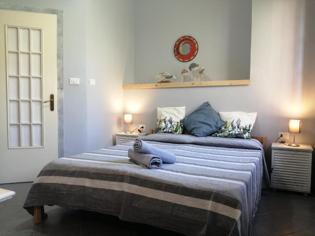 a bedroom with a large bed with blue pillows at Salvone's house B&B in Giardini Naxos