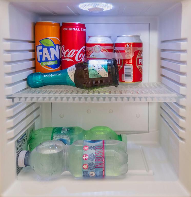 a refrigerator filled with drinks and soda at Affittacamere Le Pescatrici in Riomaggiore