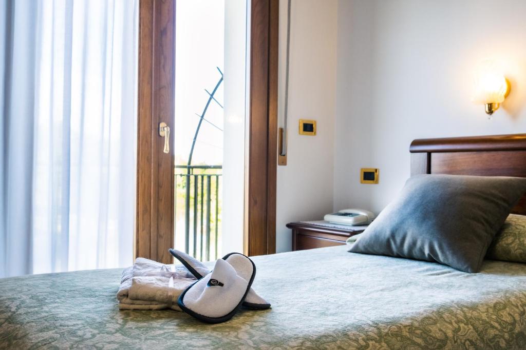 Postel nebo postele na pokoji v ubytování Hotel Da Gigi