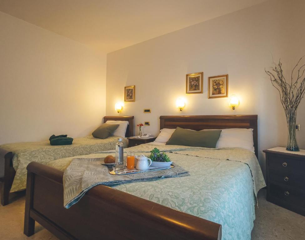 Postel nebo postele na pokoji v ubytování Hotel Da Gigi