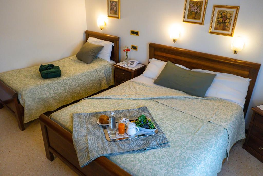Postel nebo postele na pokoji v ubytování Hotel Da Gigi