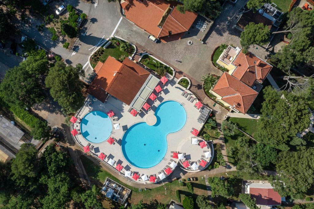 an overhead view of a swimming pool in a yard at Apartments Bellevue Plava Laguna in Poreč