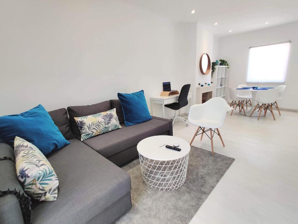 a living room with a couch and a table at Casa Sequeira in Albufeira