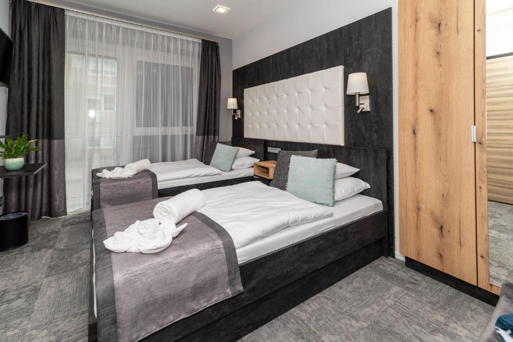 Postel nebo postele na pokoji v ubytování Arany Apartman Miskolc