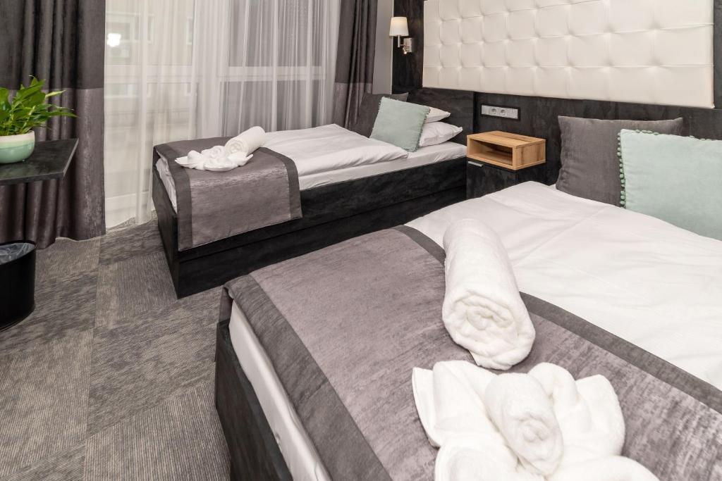 Postel nebo postele na pokoji v ubytování Arany Apartman Miskolc