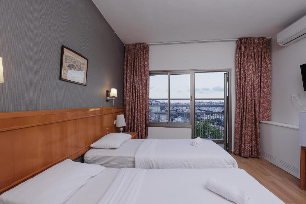 Postel nebo postele na pokoji v ubytování Tabar Hotel