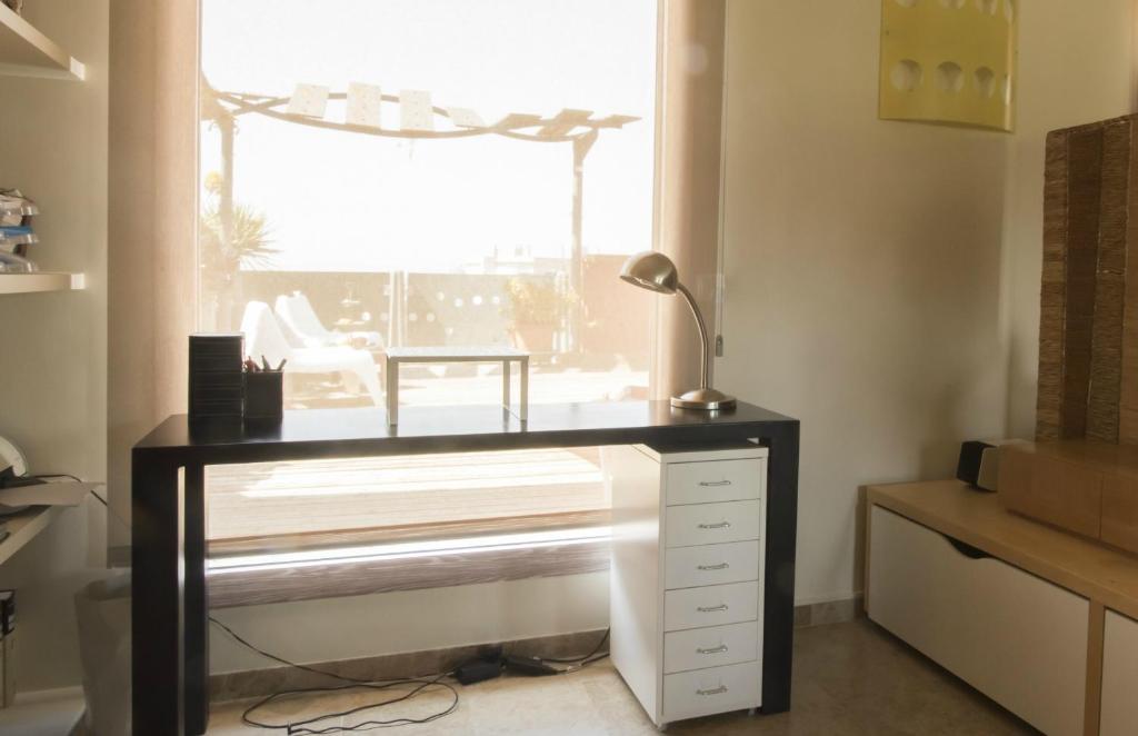 A television and/or entertainment centre at Los Condes Penthouse by Hello Homes Sitges