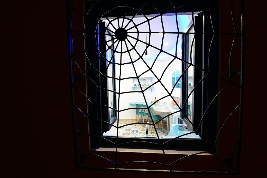 a view of a window with a chair through it at Alisaxni Studios in Argassi