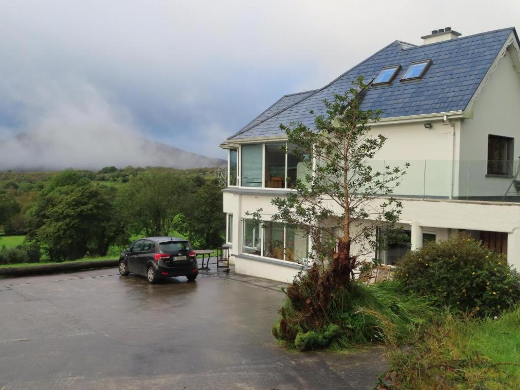 a car parked in a parking lot in front of a house at Bluebell - House in Manorhamilton