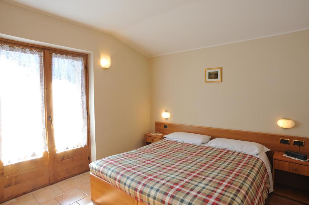 Postel nebo postele na pokoji v ubytování Hotel Ristorante San Pietro