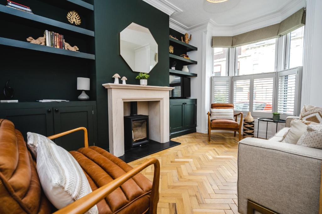 a living room with a fireplace and a couch at Best Stays York - Bishy Road Abode in York