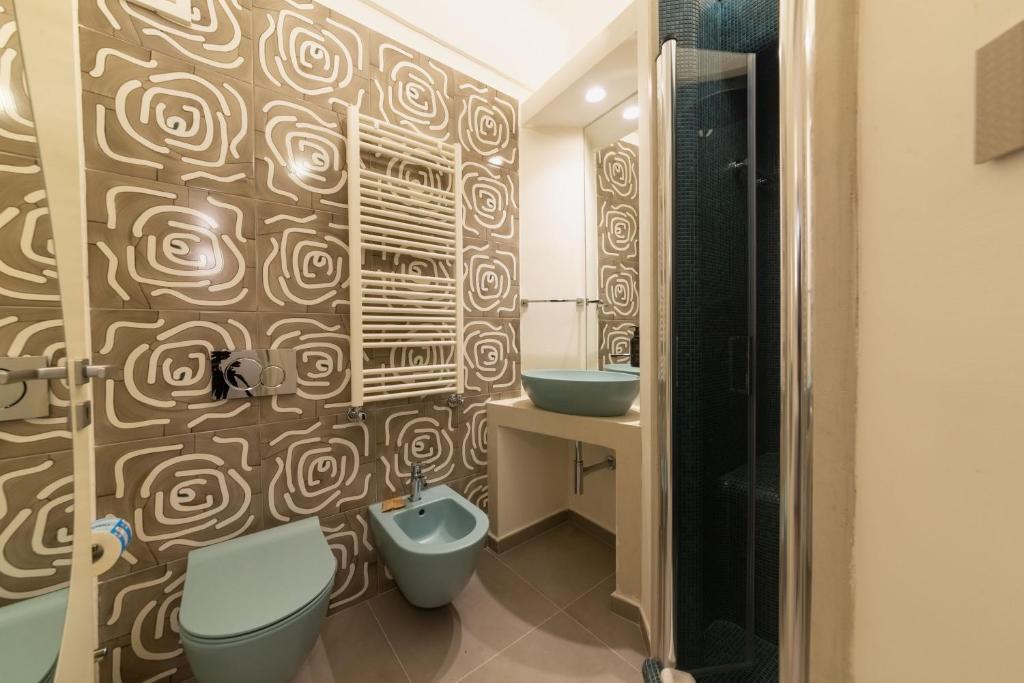 a bathroom with two sinks and two toilets at Insula Boutique Hotel in Procida