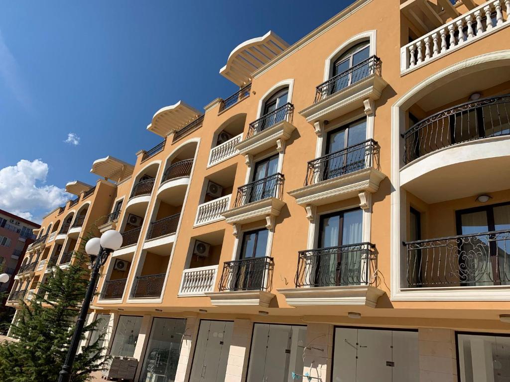a yellow building with balconies on the side of it at Apartament №1 in Villa Astoria 5 in Elenite