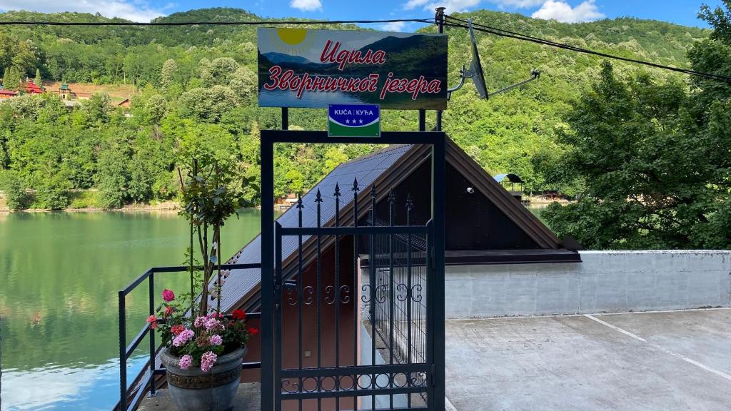 a sign for a restaurant next to a lake at Idila Zvorničkog jezera in Zvornik
