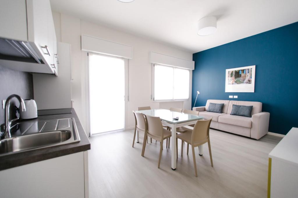 a kitchen and living room with a table and chairs at MAR60 Apartments in Caorle