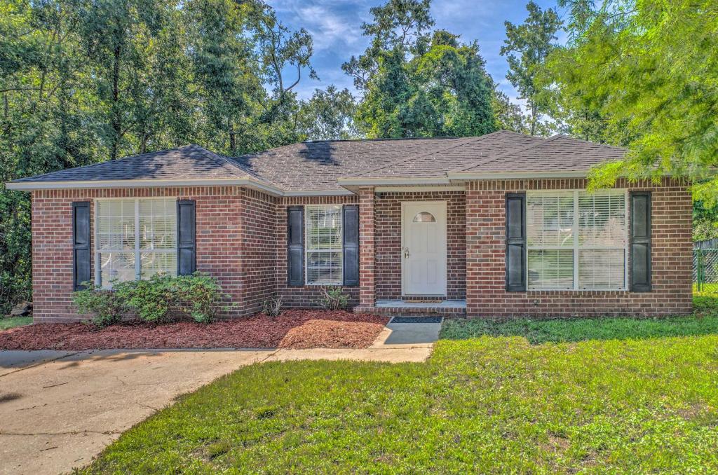a home with a brick house at Cozy Pensacola Home with Yard 10 Mi to Dtwn! in Pensacola