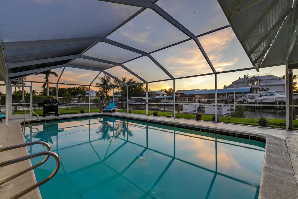 a large swimming pool with a glass roof at Good Vibes and Tan Lines! Private Beach with Heated Pool - Villa Good Times, Fort Myers Beach in Fort Myers Beach