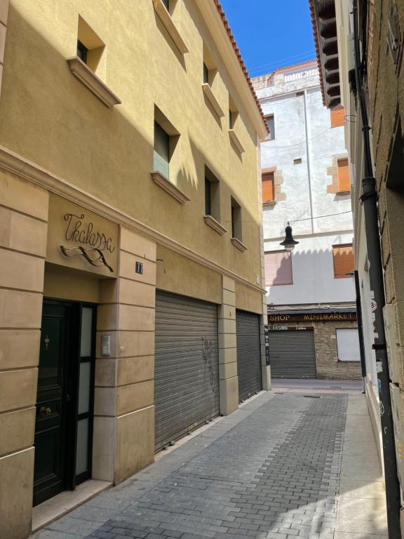 a building with two garage doors on a street at THALASSA by Ponent in Lloret de Mar