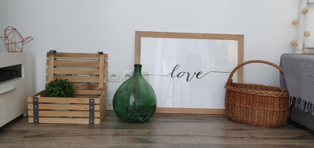 a large green vase sitting next to a sign that reads love at Appartement Ajaccio vue mer panoramique in Ajaccio