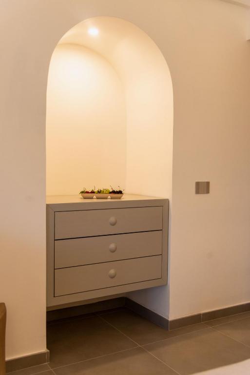 a dresser in a room with an archway at Insula Boutique Hotel in Procida