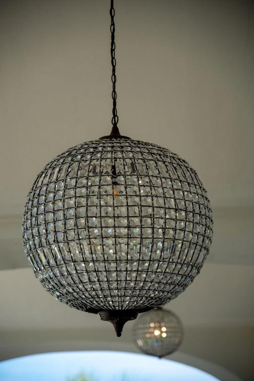 a chandelier hanging from a chain on top of a table at Insula Boutique Hotel in Procida