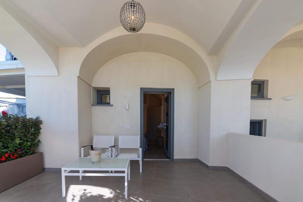a hallway with a table and chairs in a building at Insula Boutique Hotel in Procida