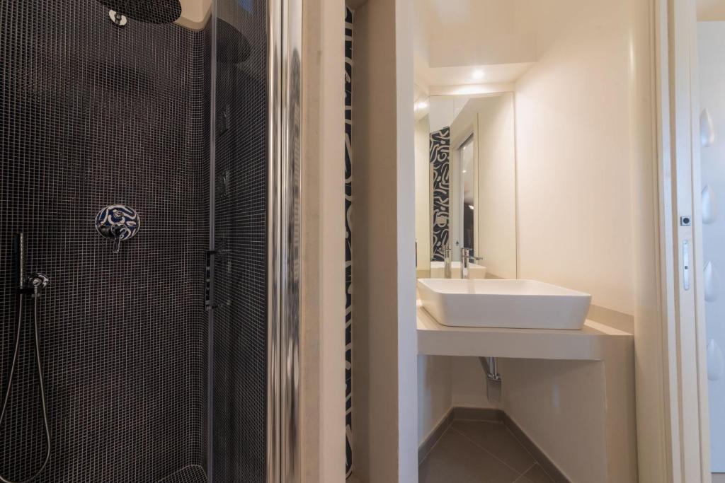 a bathroom with a sink and a shower at Insula Boutique Hotel in Procida