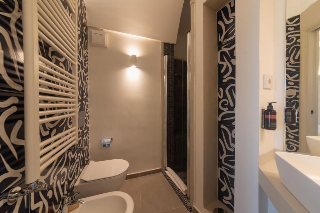 a bathroom with a toilet and a sink at Insula Boutique Hotel in Procida