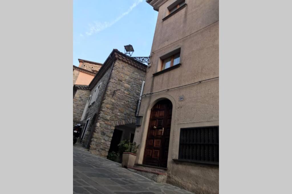 a stone building with a door on a street at B&B Casa Vacanze Al Casale in Sasso di Castalda