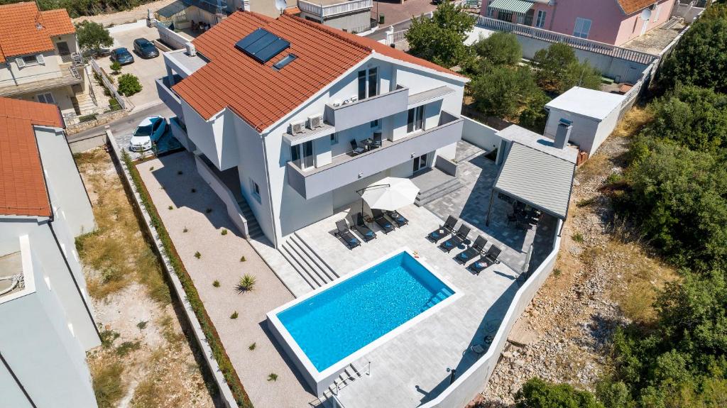 an aerial view of a house with a swimming pool at Villa Amaris in Brodarica