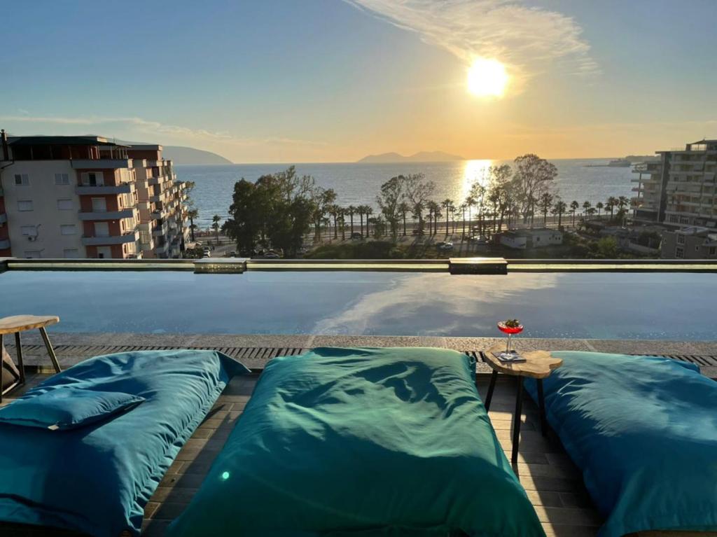 a swimming pool with two pillows on top of a building at Ames Hotel & SPA in Vlorë