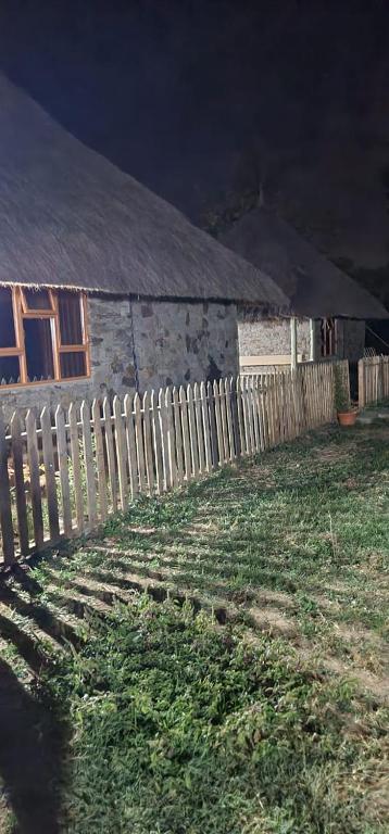 an old house with a fence next to a yard at Le Tai Village Resort near Solio Game Reserve in Mweiga