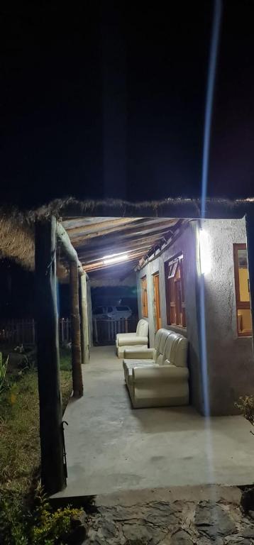 a group of couches sitting outside of a building at night at Le Tai Village Resort near Solio Game Reserve in Mweiga