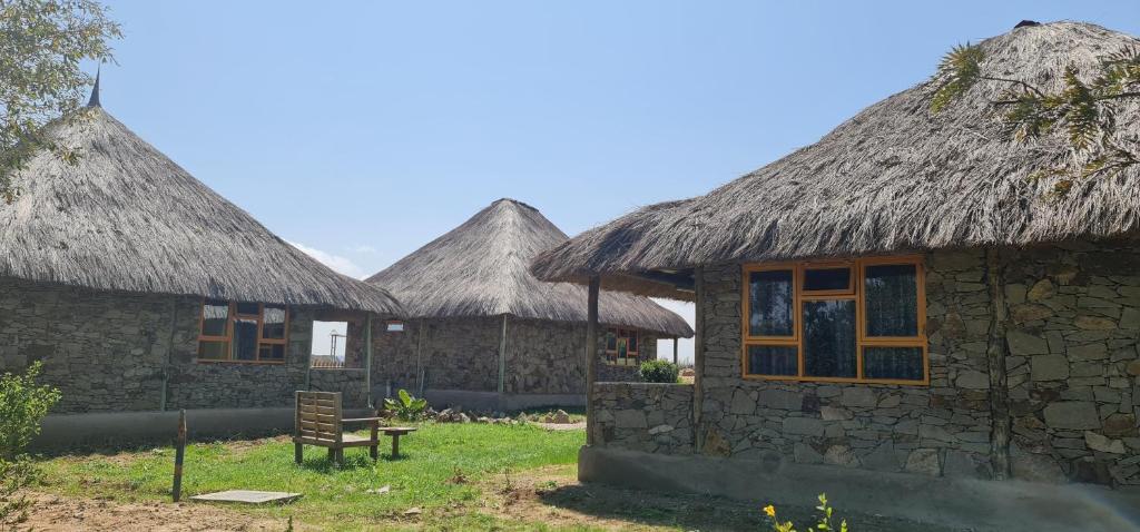 a row of huts with thatched roofs on top of it at Le Tai Village Resort near Solio Game Reserve in Mweiga