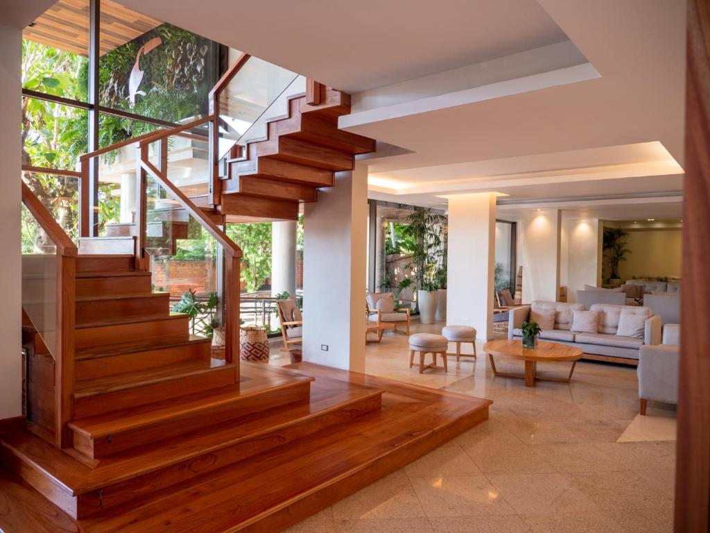 a staircase in a house with a living room at Hotel Saint George in Puerto Iguazú