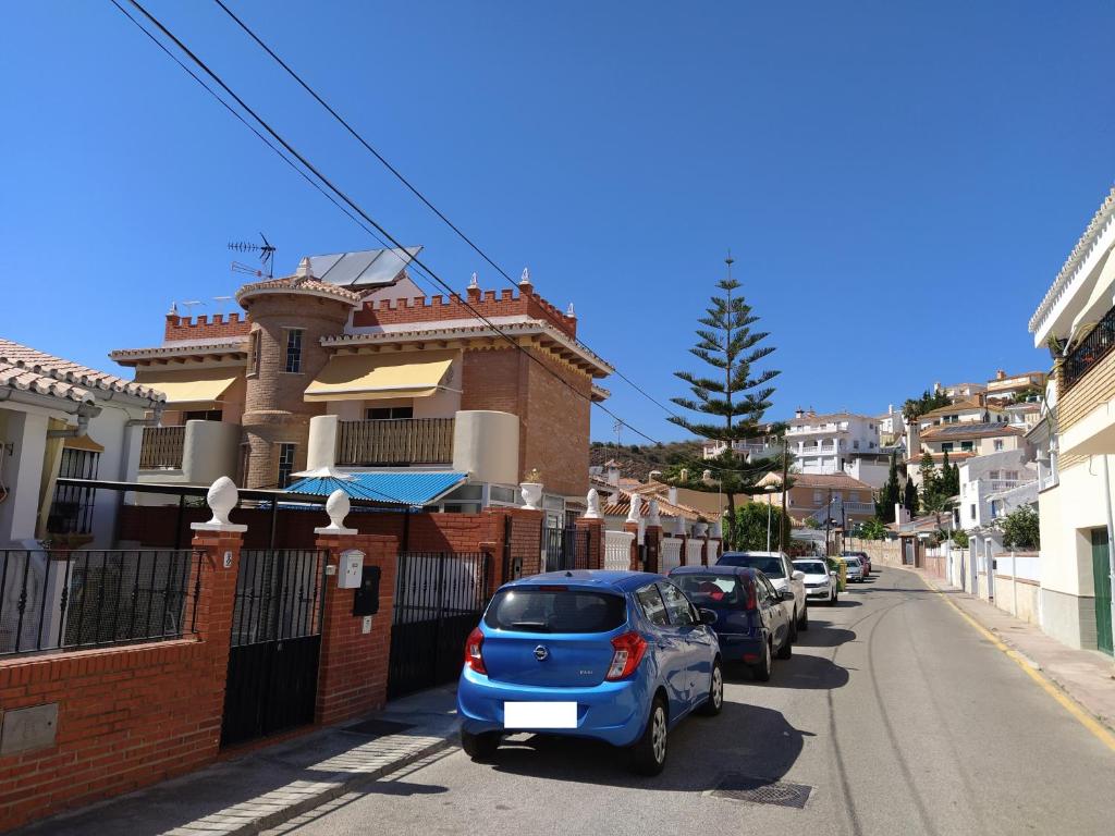 a small blue car parked on the side of a street at Monísimo Pensión Rincón de la Victoria in Rincón de la Victoria