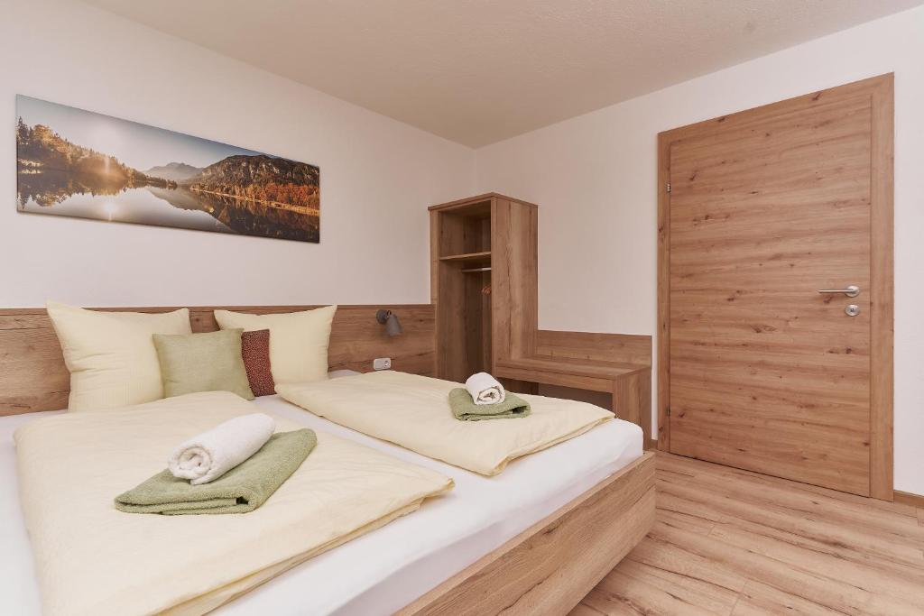 a bedroom with two beds with towels on them at Pienz Apart in Oetz