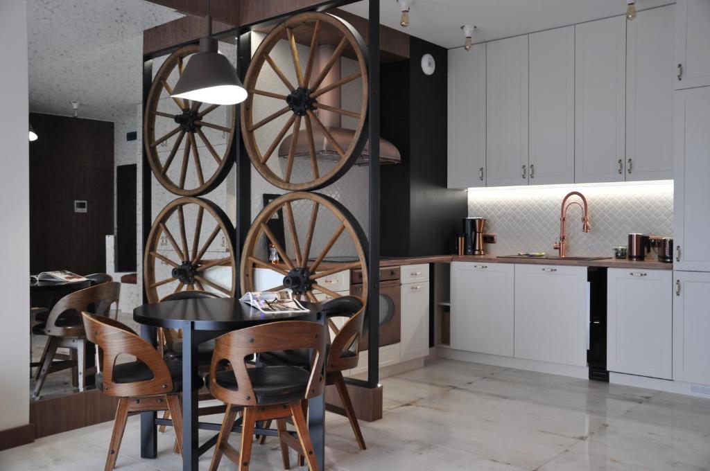una cocina con una mesa con ruedas torcidas en la pared en The Country Club, en Toruń