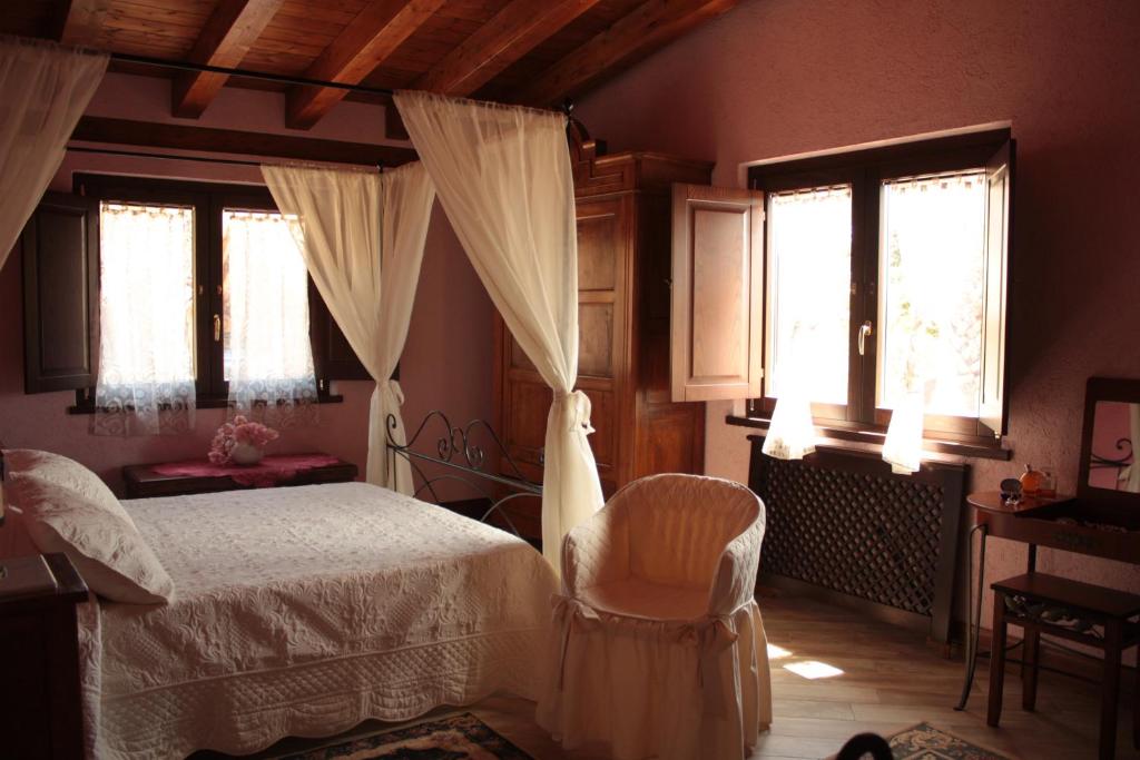 1 dormitorio con 1 cama y 2 ventanas en Relais Garden Cactus B&B en Favara