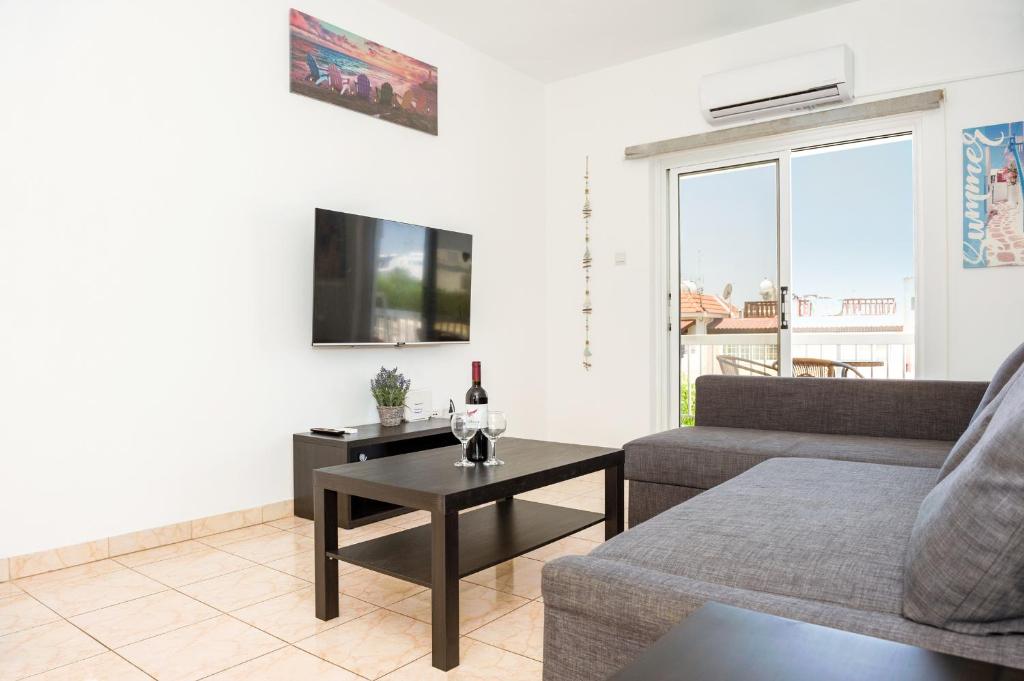 a living room with a couch and a table at MyNapa Apartments in Ayia Napa