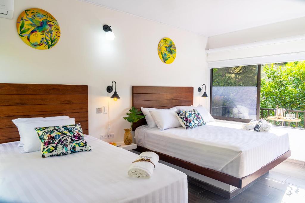 Postel nebo postele na pokoji v ubytování Hotel Nana